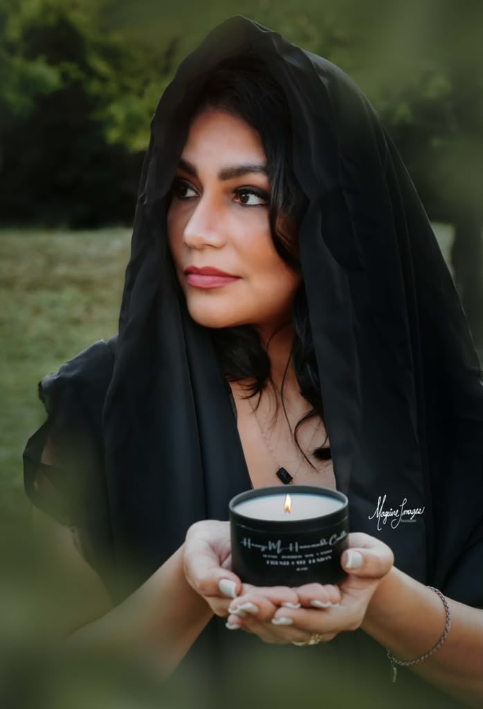 Hennys holding one of her lit candles